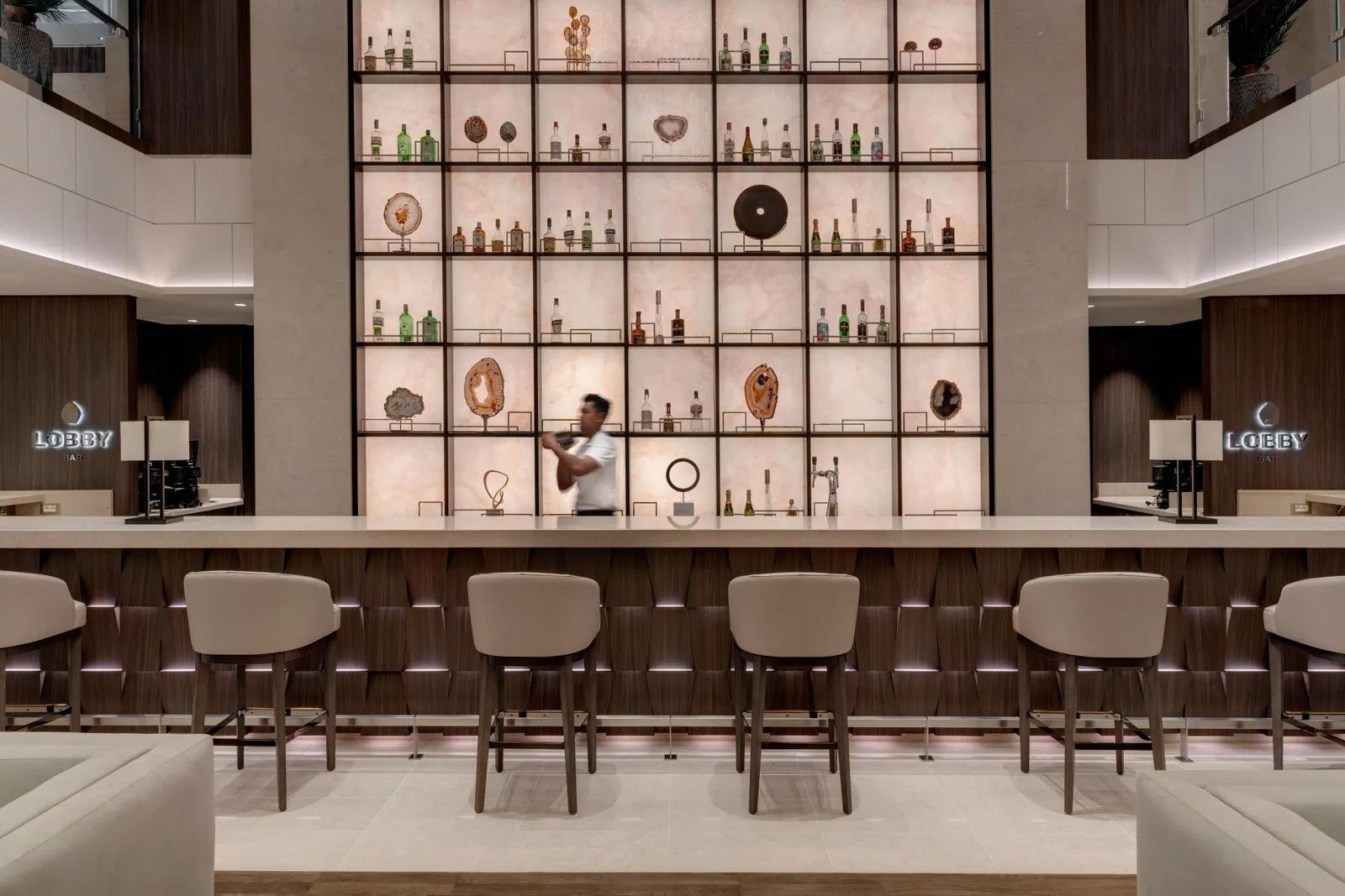 A bar and illuminated shelving within EXPLORA II.