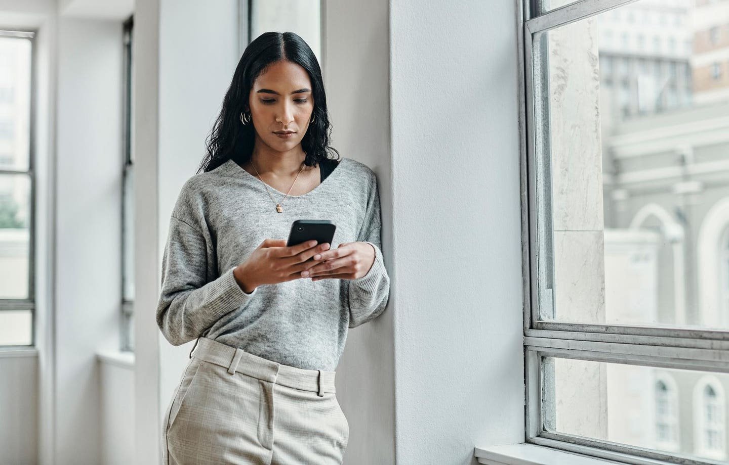 A woman researching aesthetic treatments on her smartphone