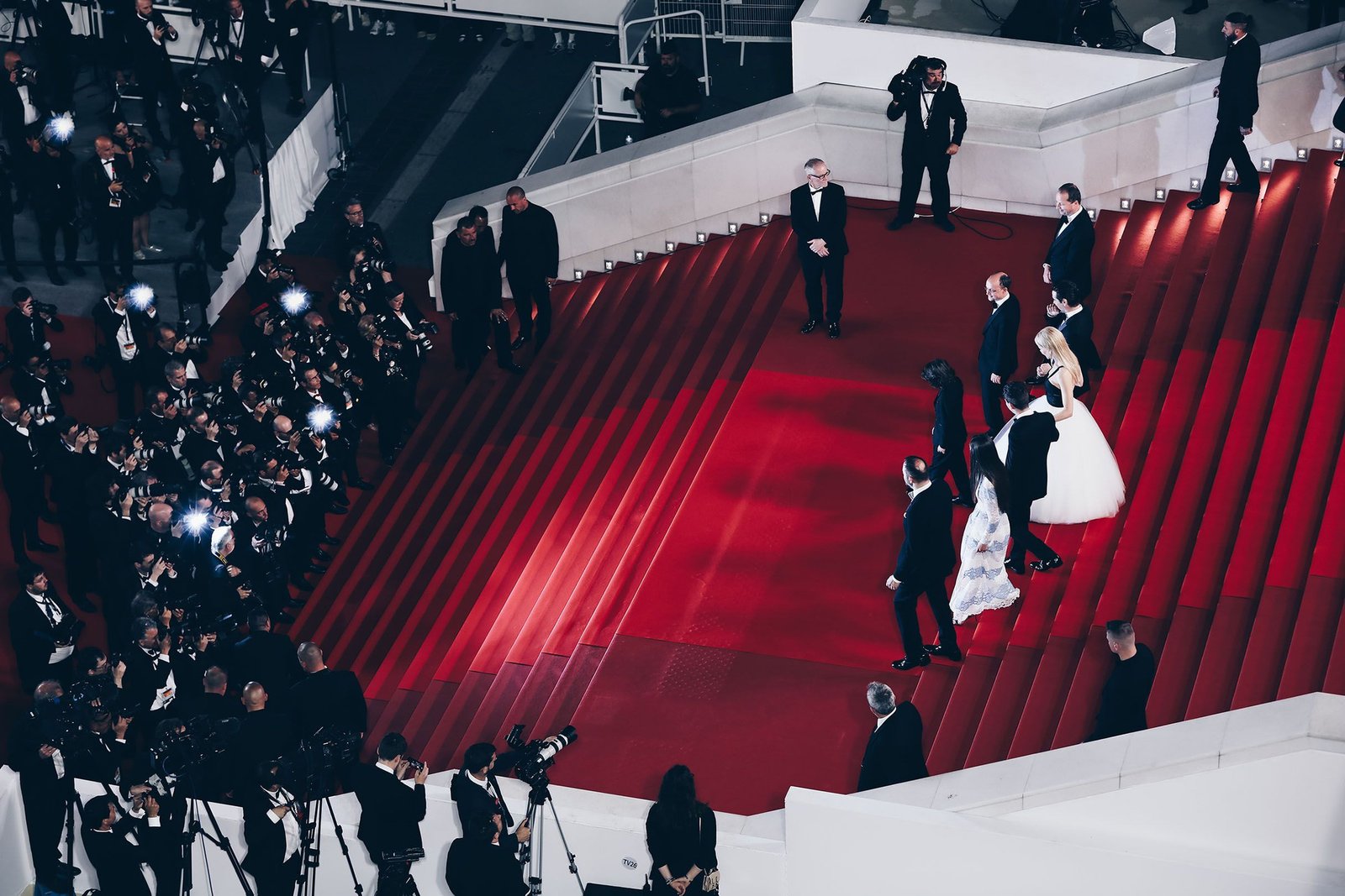 Guests climbing the red-carpeted steps of the Palais des Festivals