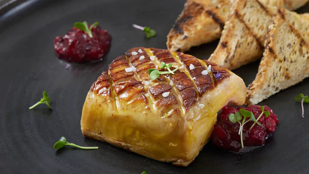 Foie gras served on a porcelain plate in a fine dining restaurant