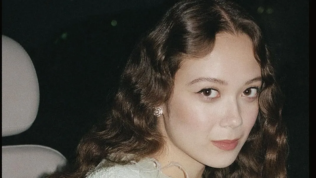 Close-up of softly defined, wide-open eyes with luminous make-up