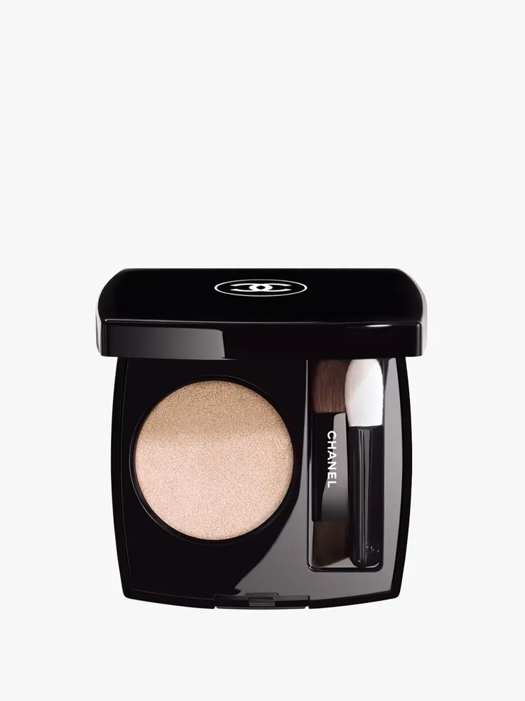 Nude eyeshadow applied to the eyelid with a brush