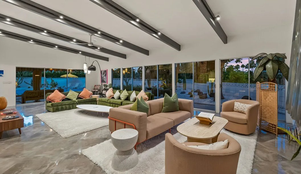 Living room with fireplace and glass doors at the Doll House, Palm Springs