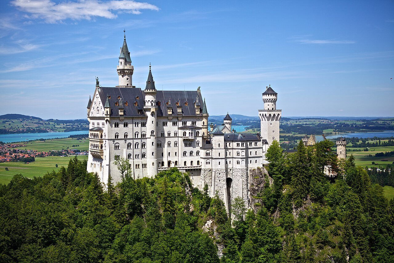 Neuschwanstein Castle above the forest in the Bavarian Alps