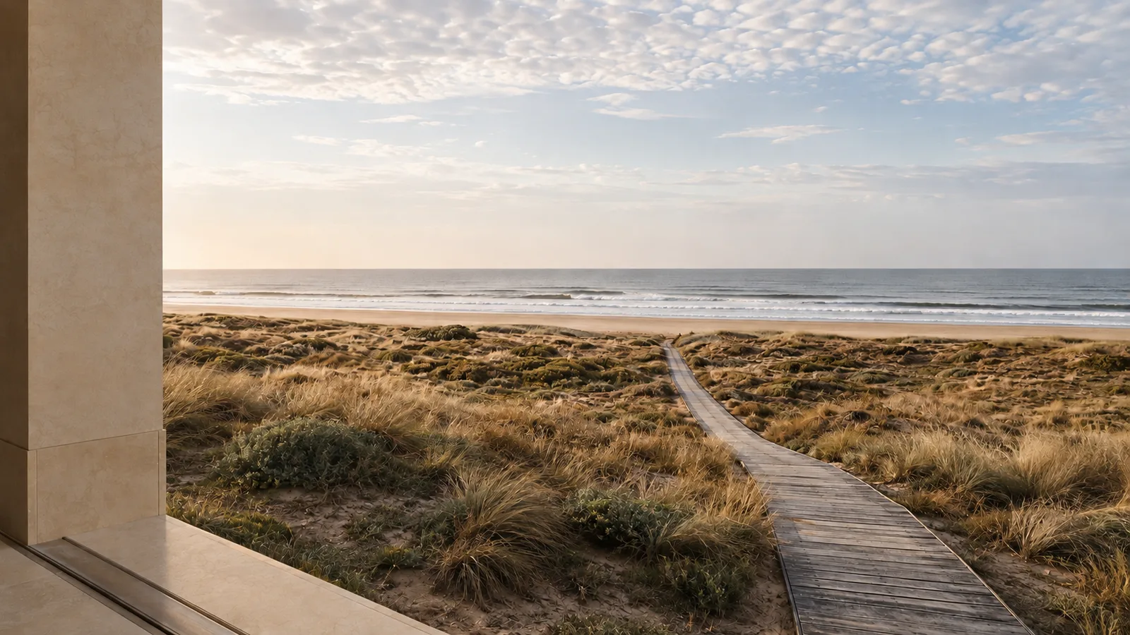 Stone portico above the dunes and a timber boardwalk to the water