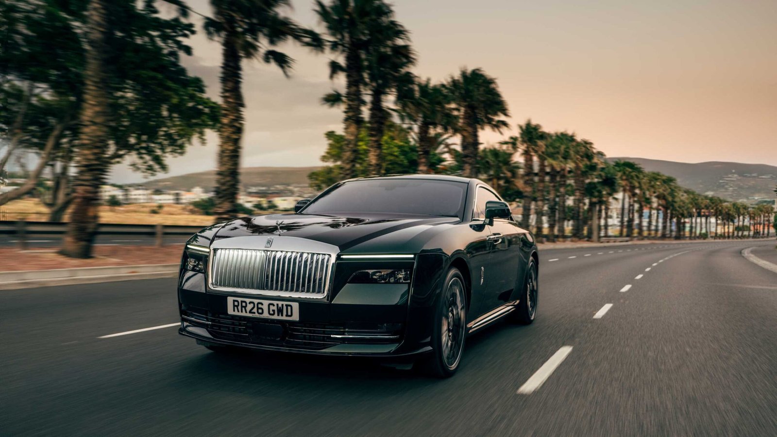 Rolls-Royce Spectre Series II on a palm-lined road