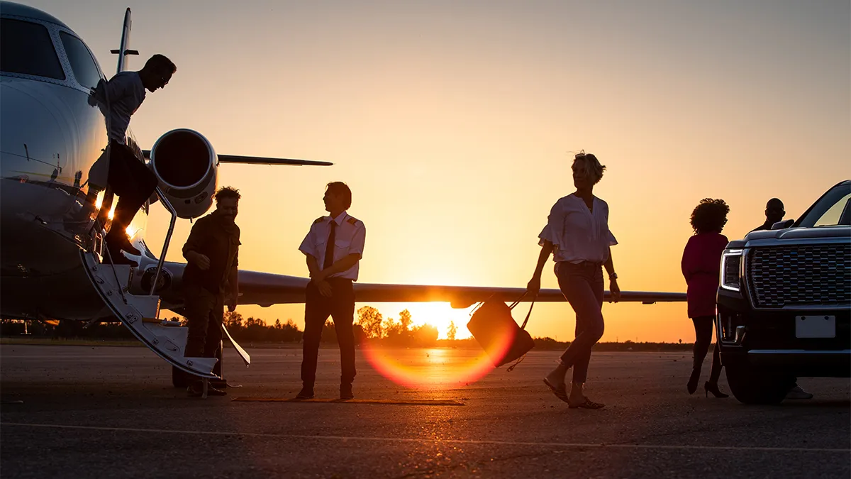 Passenger boarding a private jet by the airstair